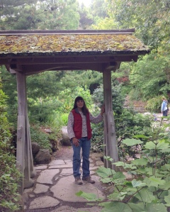 Elaine shows the donated gate at the UC-Berkeley pathway to the Japanese pond.