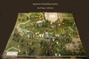 red ribbon marks size of original Japanese garden; model shows expansion completed in time for centennial